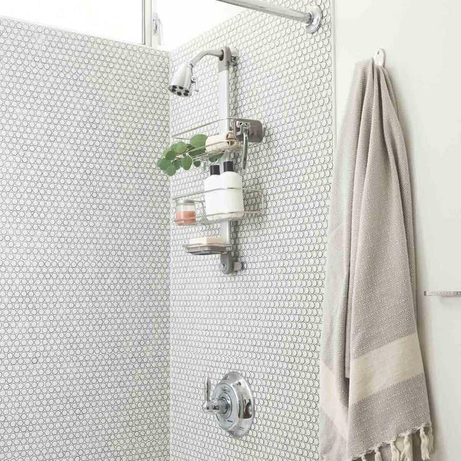 Simplehuman Polished Stainless Steel Adjustable Shower Caddy organizing shower essentials on penny tile, maximizing space.