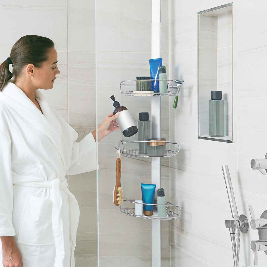 Lifestyle shot: Simplehuman Tension Shower Caddy, White/Polished Steel, adjustable shelves hold many large bottles.