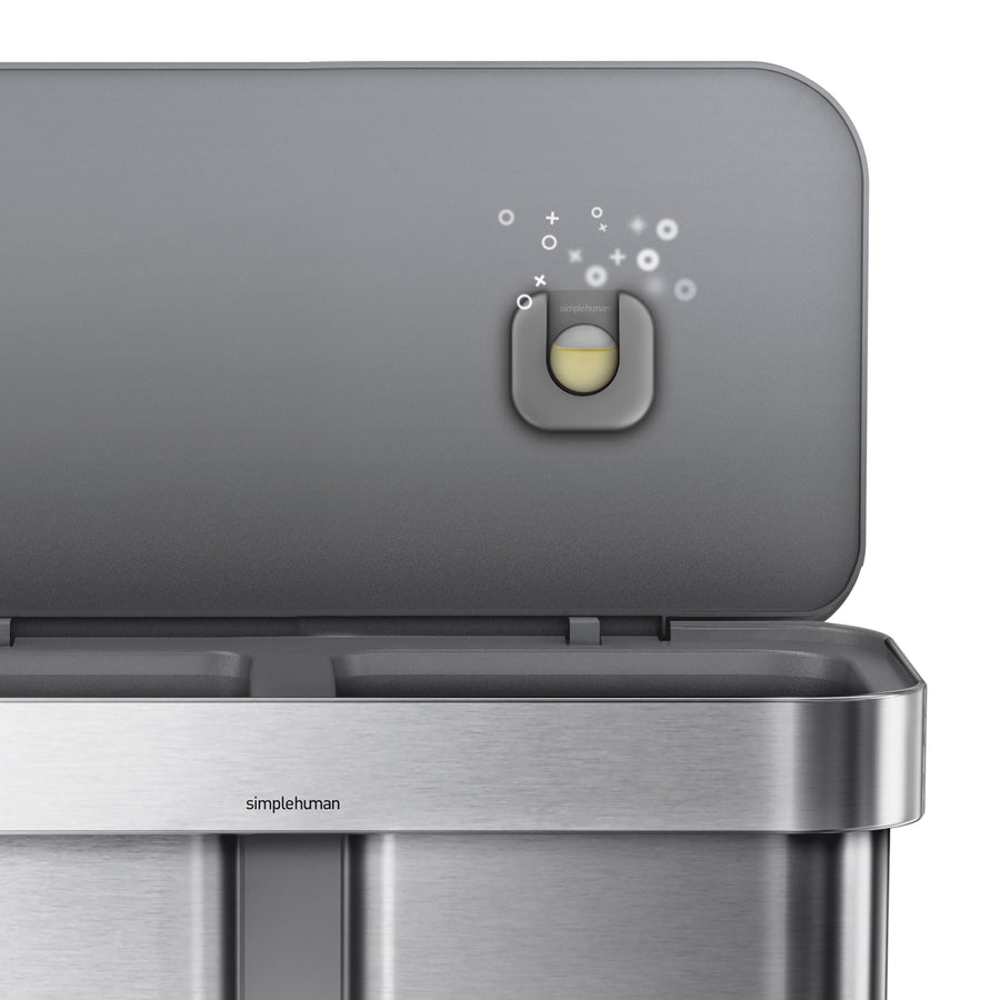 Detail view of the Simplehuman Odorsorb dispenser installed under the lid, showing the removable refill pod.