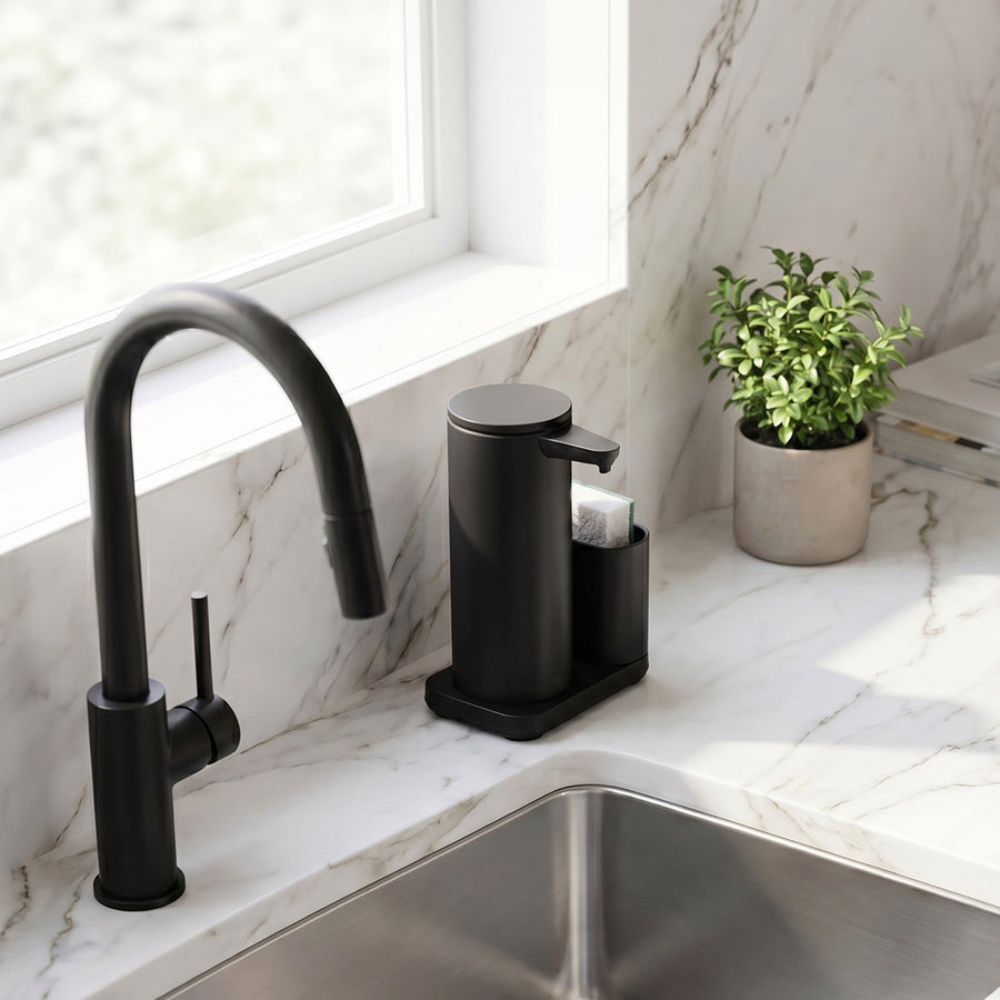 Simplehuman's 9 oz. Liquid Sensor Pump with Caddy in Matte Black in a modern kitchen setting on a marble countertop with small plants.