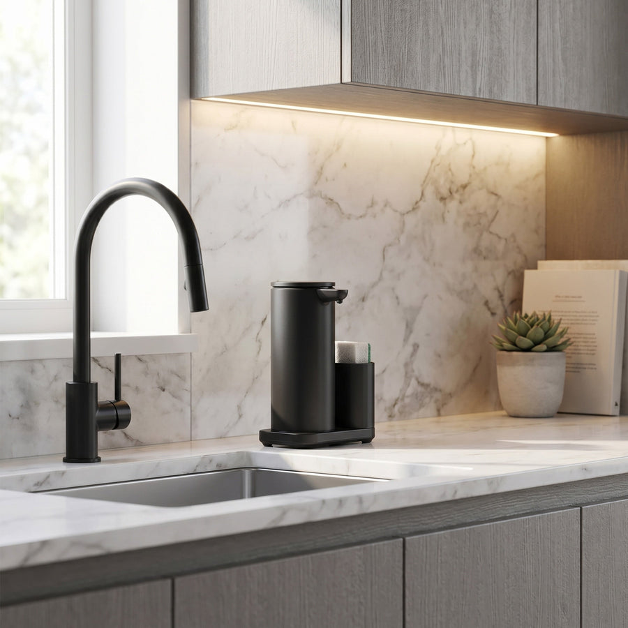 Simplehuman's Matte Black Sensor Pump with Caddy in simple kitchen setting with marble backsplash and light grey cabinets. 