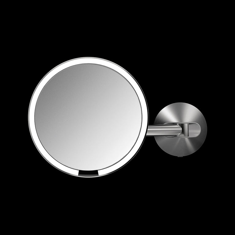 Simplehuman's wall mount mirror on a black background. 