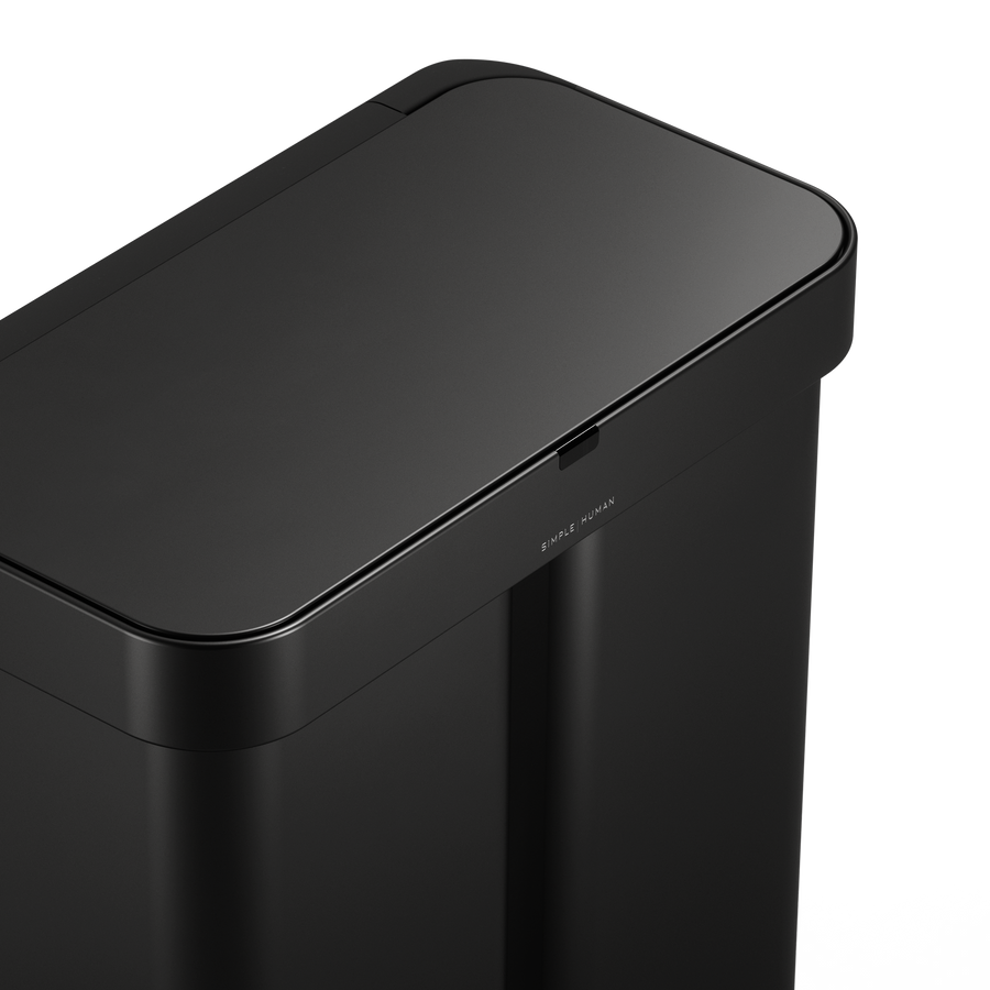 Detail view of Simplehuman Matte Black 58L Sensor Recycler lid, highlighting the logo and touch-free sensor area.